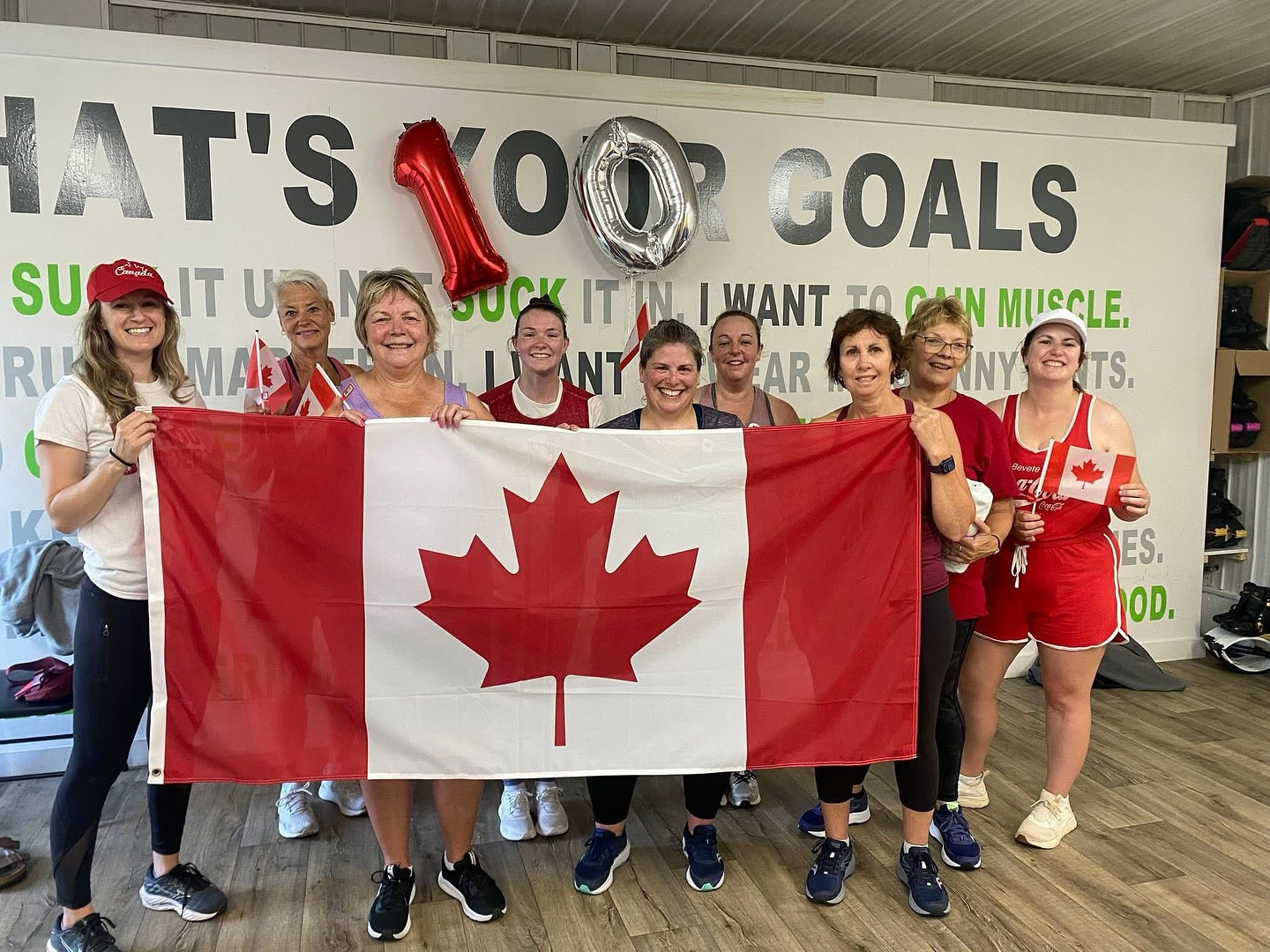 Group of people holding a Canadian flag