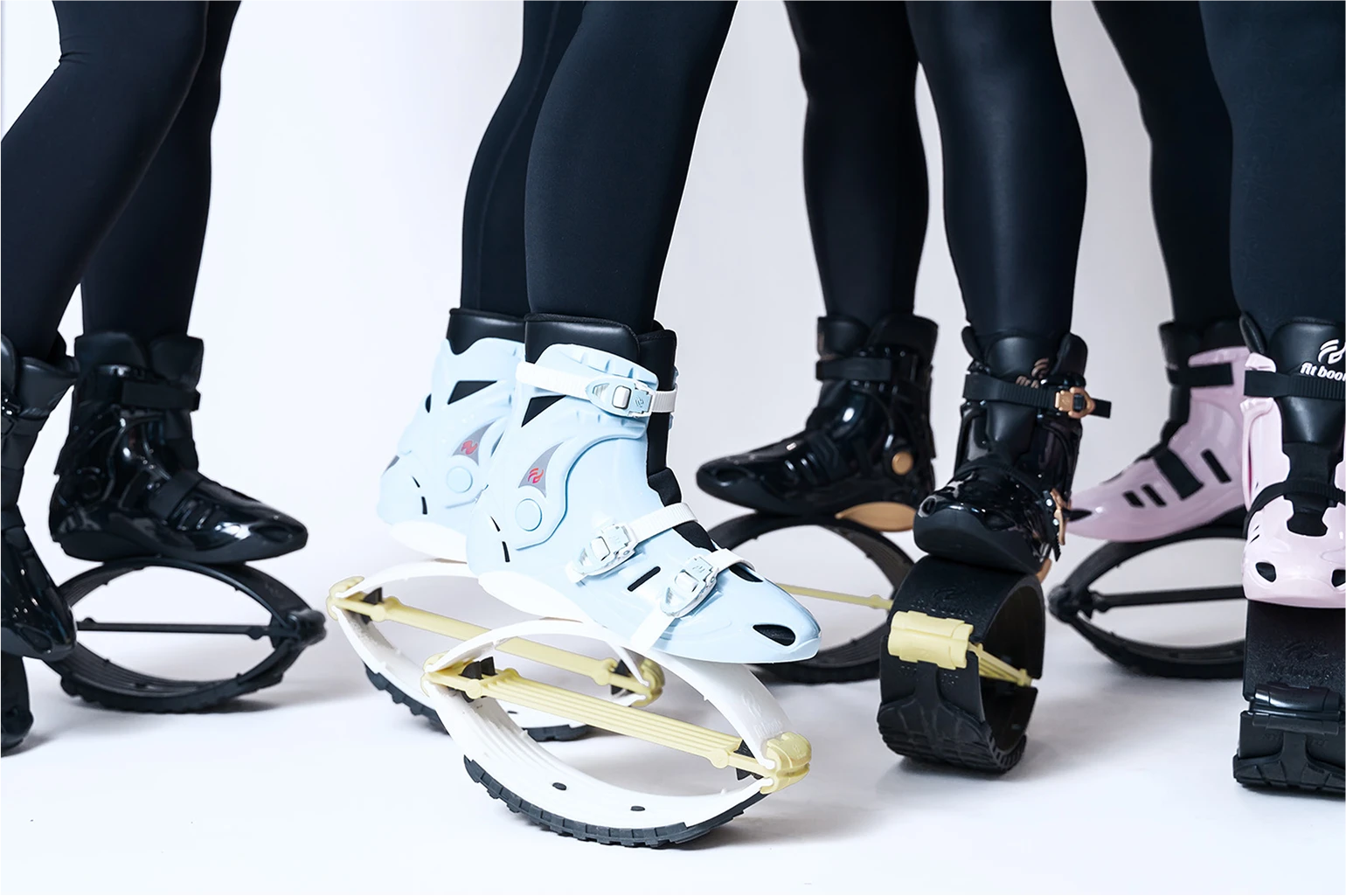 Close-up of feet wearing unique white and black shoes with弹簧设计 on a white background